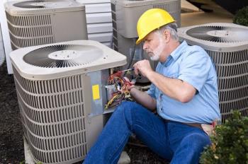A Croaker technician fixing an air conditioner in 